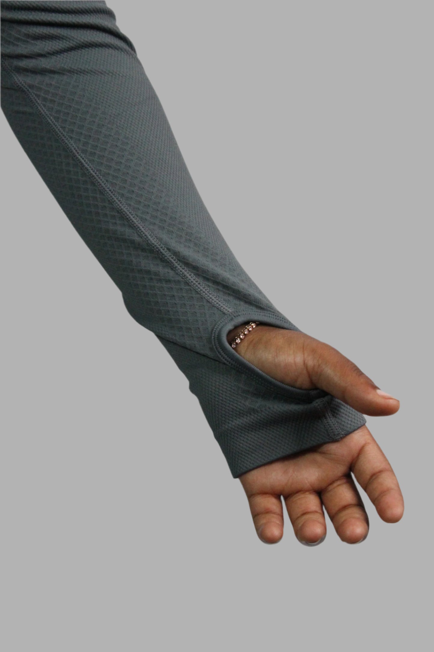 Gray wrist support brace on a person's wrist against a plain background