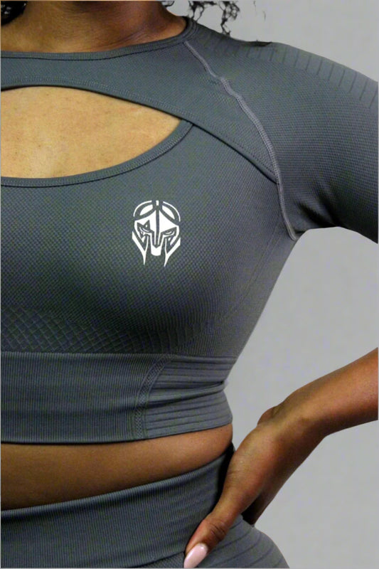 Gray athletic top with a logo on a neutral background