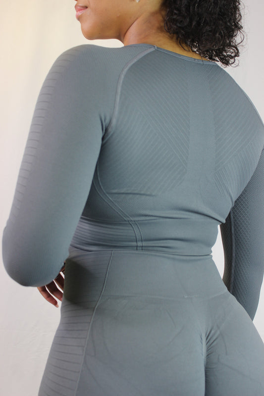 Titan's Valkyrie Long Sleeve in grey, shown on a model, featuring a stylish, fitted design with subtle branding and long sleeves.