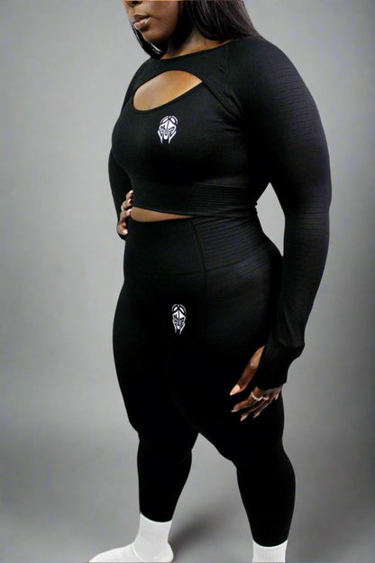 Black Valkyrie leggings by Titans, featuring a sleek fit and detailed design, shown on a model in a fitness pose.