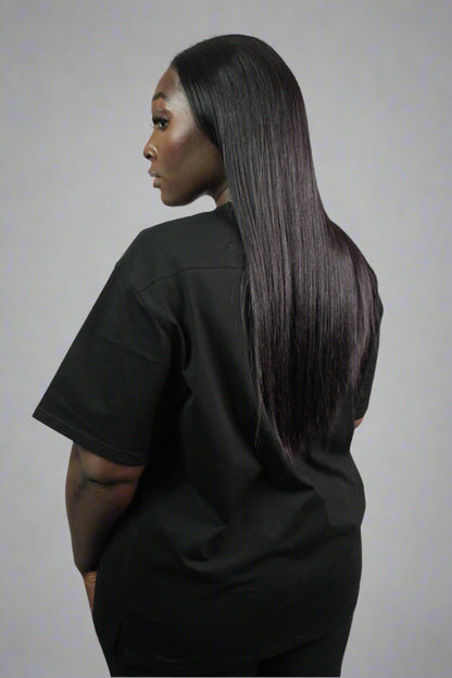 Black oversized Titans T-shirt displayed flat, showcasing its relaxed fit and soft fabric for casual, comfortable wear.
