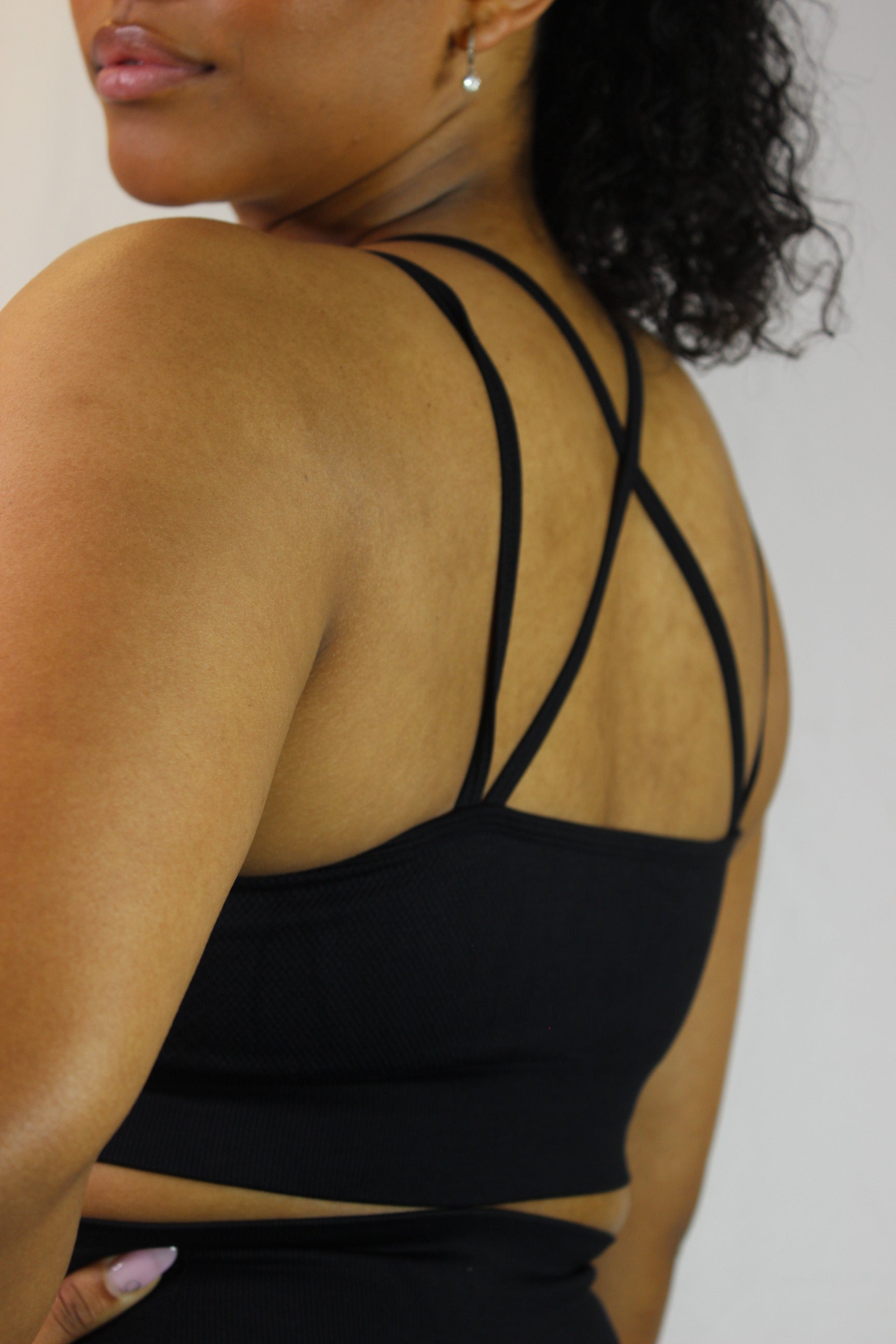 Black Valkyrie Sports Bra by Titans, showcasing a fitted athletic bra with adjustable straps and supportive design.