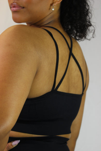 Black Valkyrie Sports Bra by Titans, showcasing a fitted athletic bra with adjustable straps and supportive design.